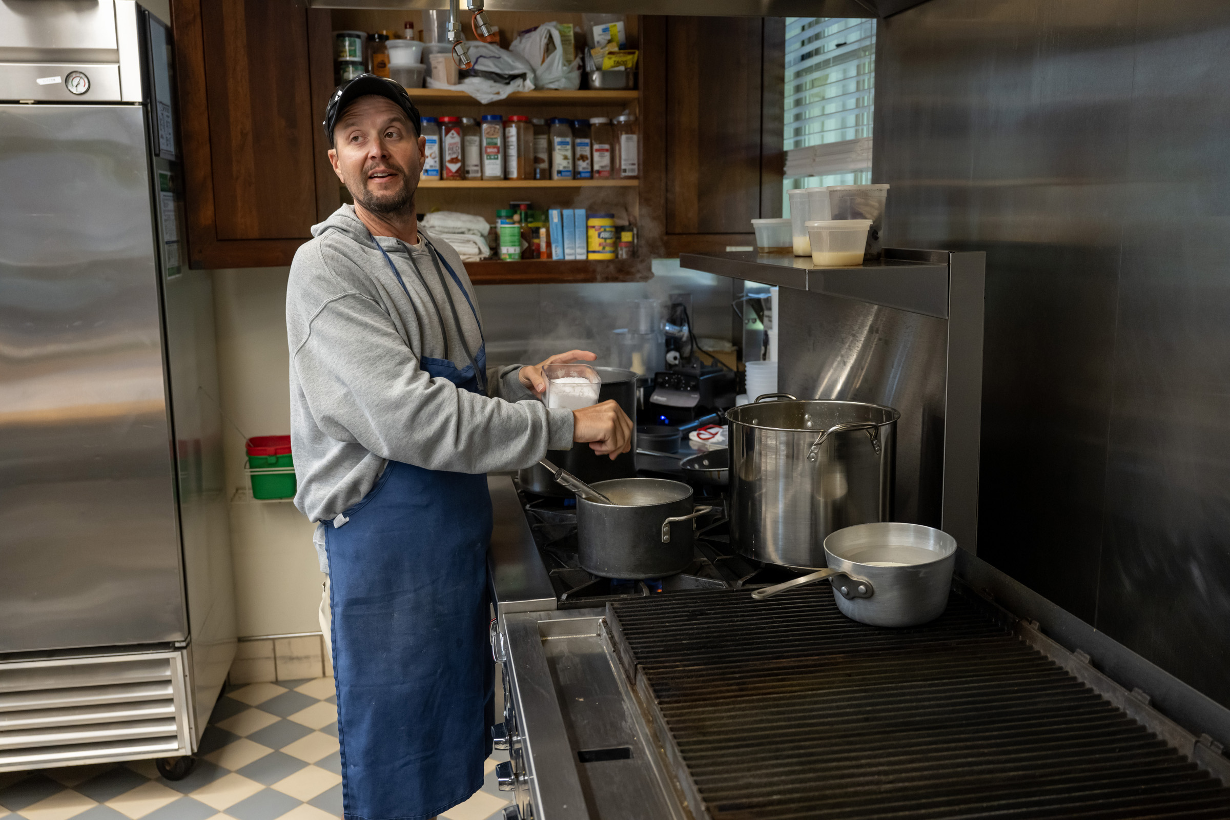 Executive Chef Brandon Kampeter seasons wine sauce in the kitchen of the Missouri Governor's Mansion.