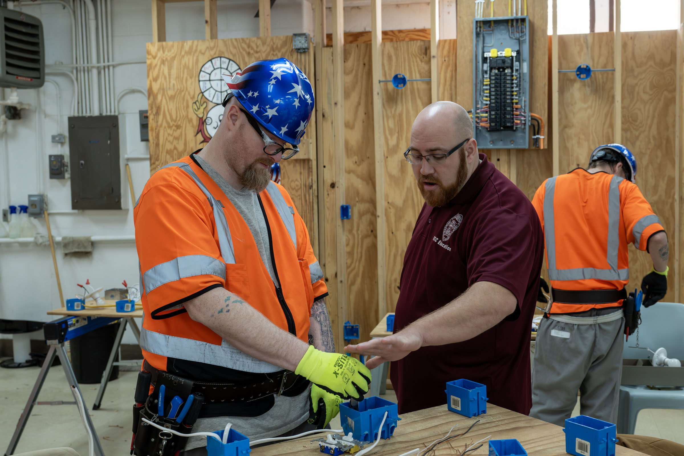 Instructor teaches electrical wiring student