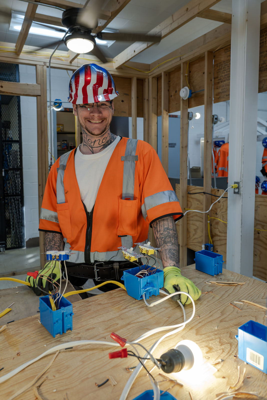 Student poses with electrical hardware
