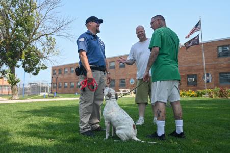 Officer talking to Puppies for Parole handlers at Moberly Correctional Center
