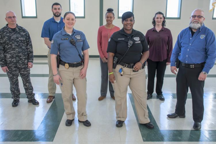 Seven staff members, some in uniform