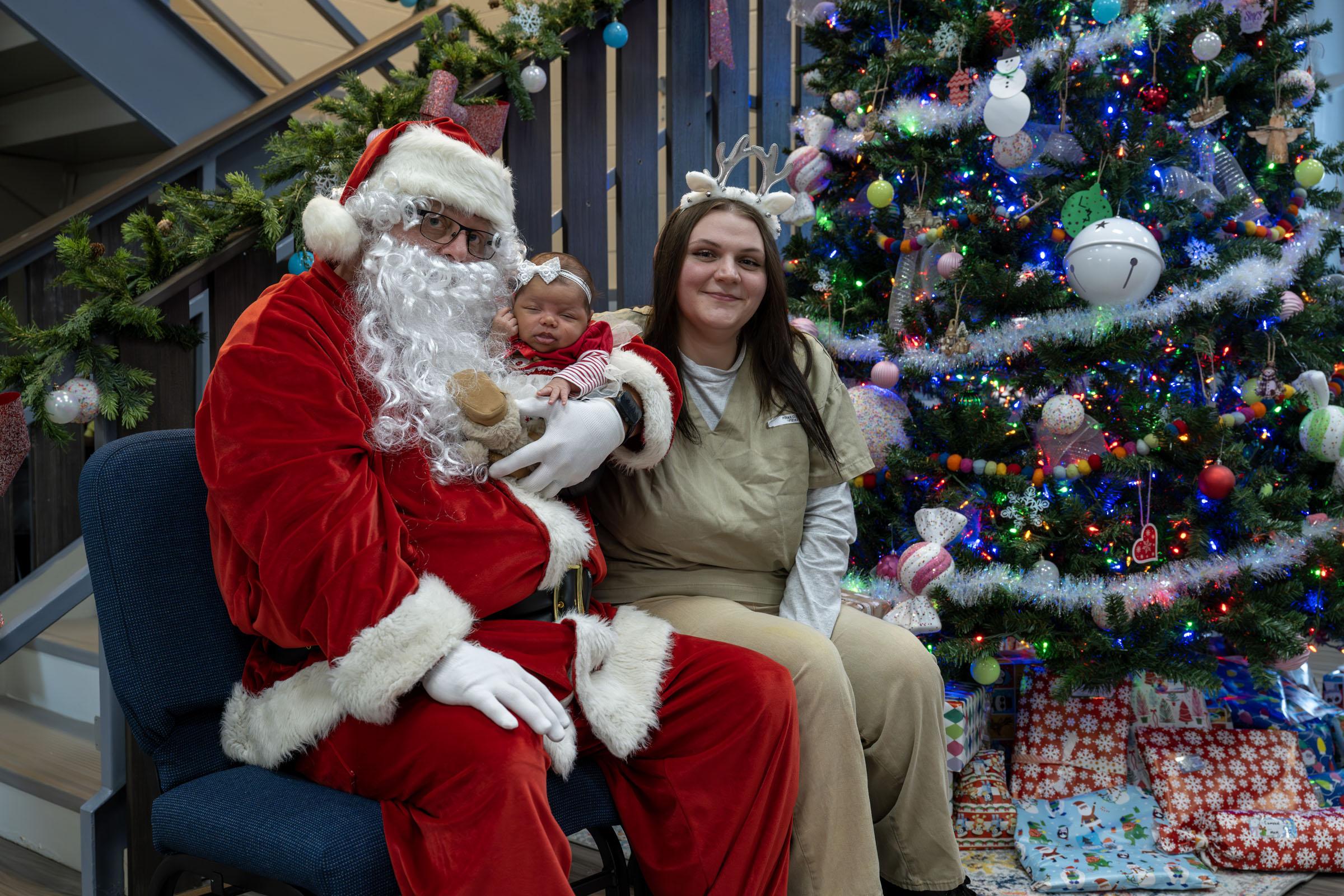Santa holds Cloey Poland's newborn, Miracle.