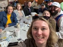 Photo of a family seated for dinner at a restaurant