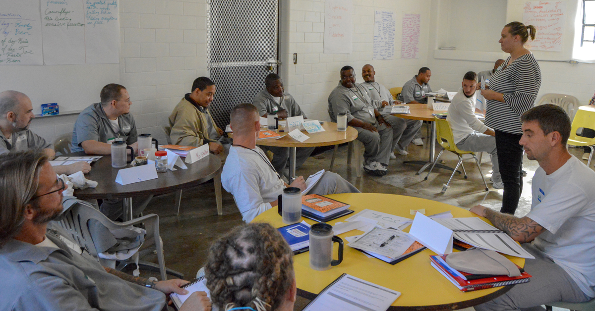 Classroom full of offenders with books and hand-written posters